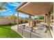 Backyard oasis with covered patio, seating, and grill at 6713 E Paradise Ln, Scottsdale, AZ 85254
