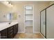 Double vanity bathroom with walk-in closet at 6802 N 86Th Ln, Glendale, AZ 85305