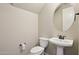 Small bathroom with pedestal sink and toilet at 6802 N 86Th Ln, Glendale, AZ 85305