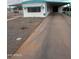 Mobile home exterior with carport and gravel driveway at 714 S 86Th Pl, Mesa, AZ 85208