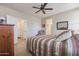 Comfortable bedroom with ceiling fan and ample closet space at 17547 W Silver Fox Way, Goodyear, AZ 85338