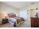 Bedroom with striped bedding and double closets at 17547 W Silver Fox Way, Goodyear, AZ 85338