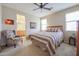 Relaxing bedroom with ceiling fan and en-suite bathroom access at 17547 W Silver Fox Way, Goodyear, AZ 85338