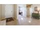 Bright entryway with tile flooring, a view of an office, and green dresser at 17547 W Silver Fox Way, Goodyear, AZ 85338
