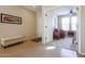 Bright entryway with tile floors and view into den at 17547 W Silver Fox Way, Goodyear, AZ 85338