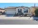 Single-story home with a two-car garage and desert landscaping at 17547 W Silver Fox Way, Goodyear, AZ 85338