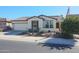 Single-story home with a two-car garage and desert landscaping at 17547 W Silver Fox Way, Goodyear, AZ 85338