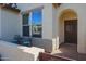 Small front patio with wrought iron furniture and a security door at 17547 W Silver Fox Way, Goodyear, AZ 85338