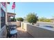 Small front patio with wrought iron furniture and a view of the street at 17547 W Silver Fox Way, Goodyear, AZ 85338