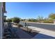 Small front patio with wrought iron furniture and a view of the street at 17547 W Silver Fox Way, Goodyear, AZ 85338