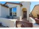Small front patio with wrought iron furniture and a security door at 17547 W Silver Fox Way, Goodyear, AZ 85338