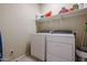 Laundry room with washer, dryer, and shelving at 17547 W Silver Fox Way, Goodyear, AZ 85338