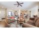 Bright living room featuring comfortable sofas and a convenient coffee table at 17547 W Silver Fox Way, Goodyear, AZ 85338