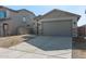 Single-story home with gray exterior, stone accents, and a two-car garage at 23227 W Florence Ave, Buckeye, AZ 85326