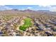 Community aerial view showcasing a golf course surrounded by beautiful homes and scenic mountain backdrop at 3055 N Red Mountain Mtn # 95, Mesa, AZ 85207