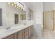 Bright bathroom featuring a double sink vanity and a glass-enclosed shower stall at 3055 N Red Mountain Mtn # 95, Mesa, AZ 85207
