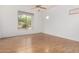 Bright bedroom with wood floors, large window, and neutral walls at 3055 N Red Mountain Mtn # 95, Mesa, AZ 85207