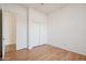 Empty bedroom with wood floors, closet, and an adjacent bathroom at 3055 N Red Mountain Mtn # 95, Mesa, AZ 85207