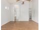 Spacious bedroom with wood floors, connecting bathroom, and laundry room access at 3055 N Red Mountain Mtn # 95, Mesa, AZ 85207