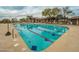 Large community pool with lane markers and plenty of lounge chairs at 3055 N Red Mountain Mtn # 95, Mesa, AZ 85207