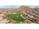 Aerial of golf course in a neighborhood surrounded by desert landscaping and mountain views at 3055 N Red Mountain Mtn # 95, Mesa, AZ 85207