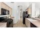 Functional kitchen with black appliances, and light countertops at 3055 N Red Mountain Mtn # 95, Mesa, AZ 85207