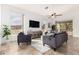 Bright living room featuring tiled floor, large windows, comfortable seating, and a ceiling fan at 3055 N Red Mountain Mtn # 95, Mesa, AZ 85207