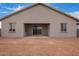 View of the back of the home with covered patio overlooking a large backyard at 31465 N Wet Creek Rd, San Tan Valley, AZ 85143