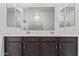 Spacious bathroom featuring a double sink vanity with quartz countertop, mirrors, and a glass door shower at 31465 N Wet Creek Rd, San Tan Valley, AZ 85143