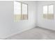 Bright bedroom featuring neutral paint, tile flooring, base molding, and windows with natural light at 31465 N Wet Creek Rd, San Tan Valley, AZ 85143