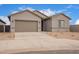 Charming single-story home with a two-car garage and low-maintenance desert landscaping at 31465 N Wet Creek Rd, San Tan Valley, AZ 85143