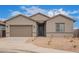 Charming single-story home with a two-car garage and low-maintenance desert landscaping at 31465 N Wet Creek Rd, San Tan Valley, AZ 85143