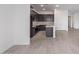 Modern kitchen featuring dark cabinetry, tile backsplash, an island with a sink, and stainless steel appliances at 31465 N Wet Creek Rd, San Tan Valley, AZ 85143