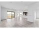 Bright, open-concept living space with tile flooring and sliding glass doors to the backyard at 31465 N Wet Creek Rd, San Tan Valley, AZ 85143