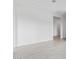 Minimalist living room featuring tile flooring, neutral paint, base molding, and access to other rooms at 31465 N Wet Creek Rd, San Tan Valley, AZ 85143