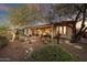 Enclosed backyard with patio, fountain and mature trees at 41348 N Congressional Dr, Anthem, AZ 85086
