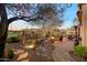 Backyard with fire pit, pathway, and desert landscaping at 41348 N Congressional Dr, Anthem, AZ 85086