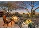 Landscaped backyard featuring a fire pit and water feature at 41348 N Congressional Dr, Anthem, AZ 85086