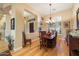Bright dining room with hardwood floors, wood table, and chandelier at 41348 N Congressional Dr, Anthem, AZ 85086