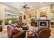 Spacious living room with hardwood floors, fireplace, and views to backyard at 41348 N Congressional Dr, Anthem, AZ 85086