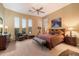 Spacious main bedroom with plush bedding, large windows, and hardwood floors at 41348 N Congressional Dr, Anthem, AZ 85086