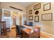 Home office with large desk and access to bathroom at 41348 N Congressional Dr, Anthem, AZ 85086