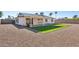 Home's backyard with covered patio and artificial grass at 5240 E Tierra Buena Ln, Scottsdale, AZ 85254