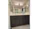 Double vanity bathroom with dark cabinets and quartz countertop at 6891 W Via Del Sol Dr, Glendale, AZ 85310