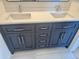 Double vanity bathroom with dark cabinets and quartz countertop at 6891 W Via Del Sol Dr, Glendale, AZ 85310