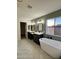 Spa-like bathroom with double vanity, soaking tub, and herringbone tile at 6891 W Via Del Sol Dr, Glendale, AZ 85310