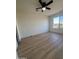 Bright bedroom with large window and wood-look flooring at 6891 W Via Del Sol Dr, Glendale, AZ 85310