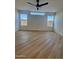 Bright bedroom with wood-look floors, large windows, and ceiling fan at 6891 W Via Del Sol Dr, Glendale, AZ 85310