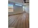 Bright bedroom with wood-look floors, large windows, and ceiling fan at 6891 W Via Del Sol Dr, Glendale, AZ 85310