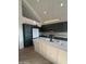 Contemporary kitchen featuring dark green cabinetry, white island, and high-end finishes at 6891 W Via Del Sol Dr, Glendale, AZ 85310